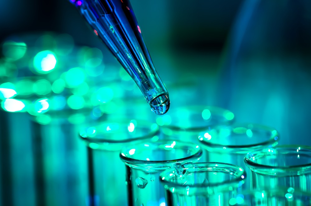 A pipette dispensing liquid into a laboratory sample